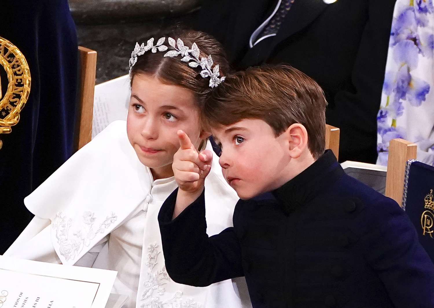 Prince Louis pointing next to Princess Charlotte