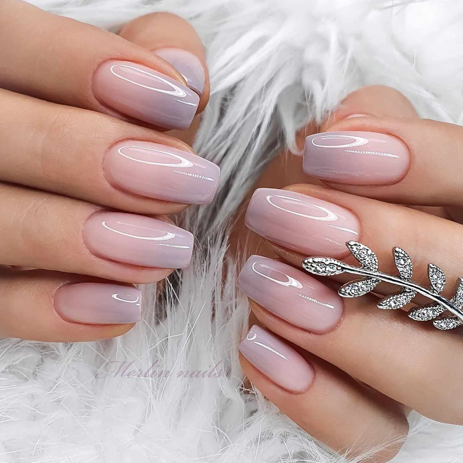 close up of nails with light pink and grey ombre manicure