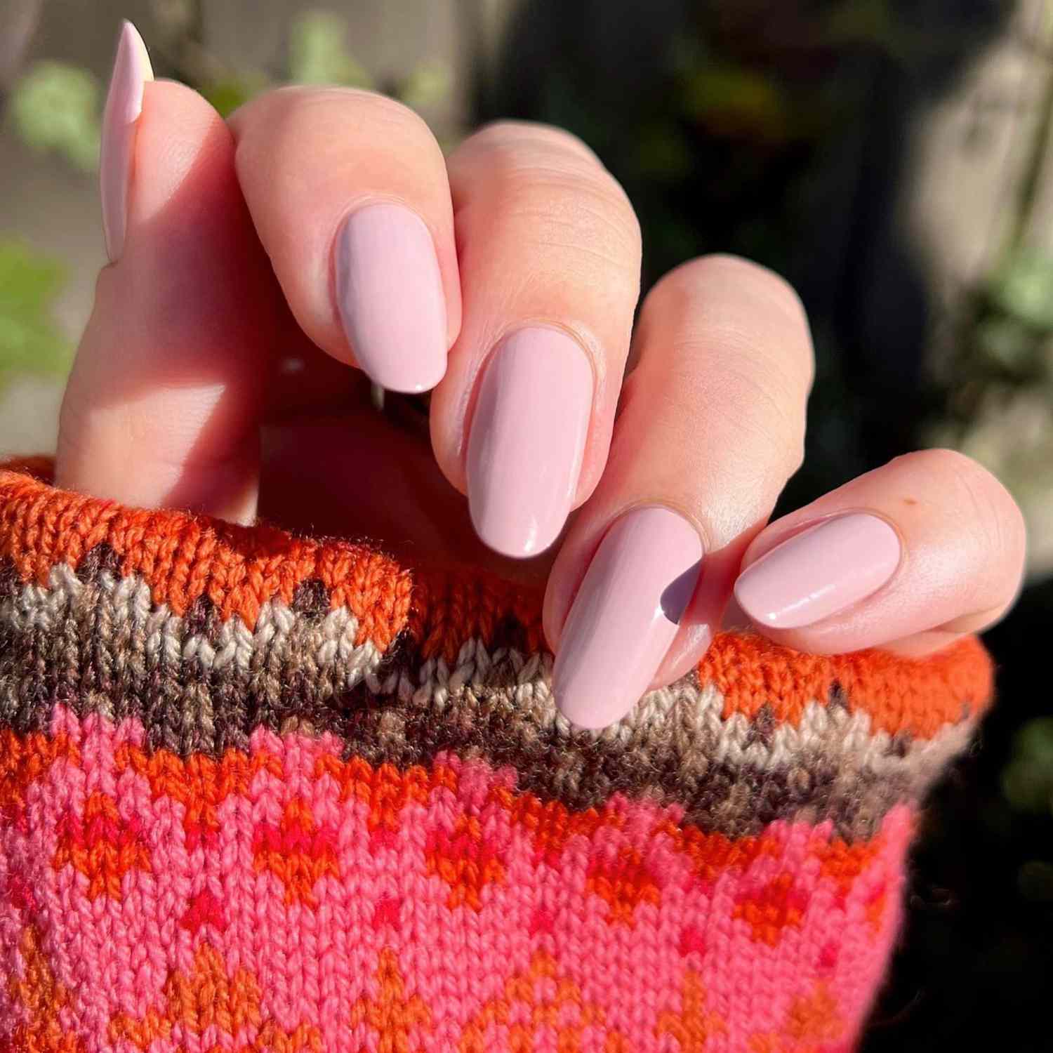 close up of nails with light pink manicure