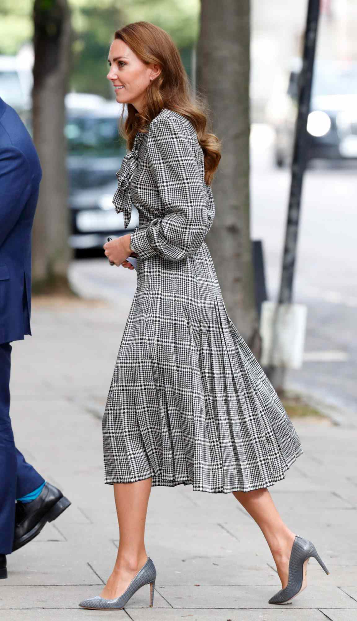 Kate Middleton in a black-and-white plaid dress with gray pumps