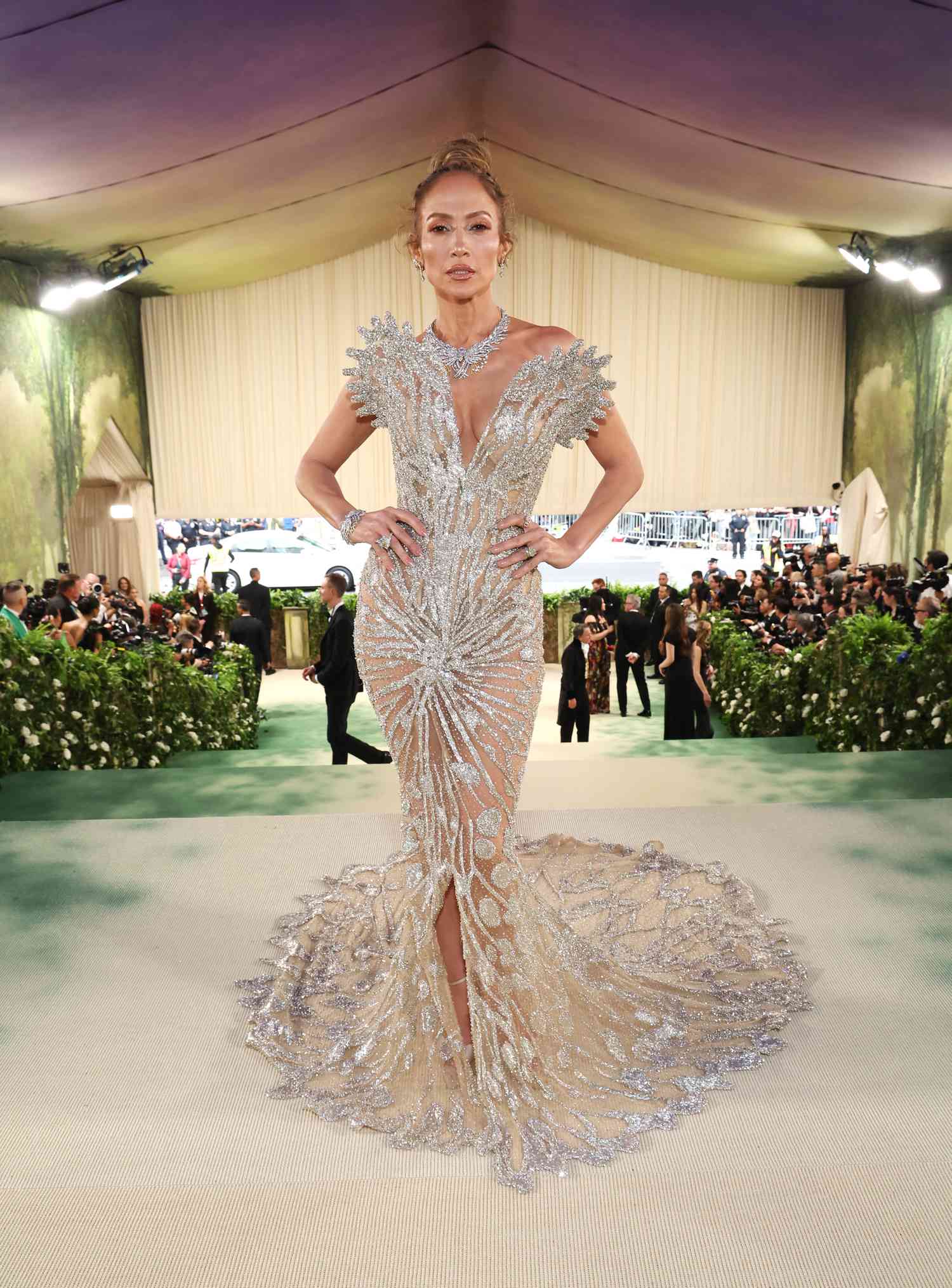 Jennifer Lopez poses for a photo in a bejeweled silver gown