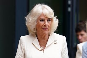 Queen Camilla wearing white suit dress