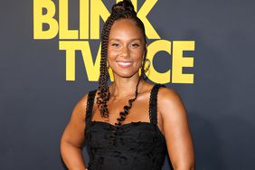 Alicia Keys Wearing Black Crop Top and Matching Long Tiered Skirt and Suede Boots