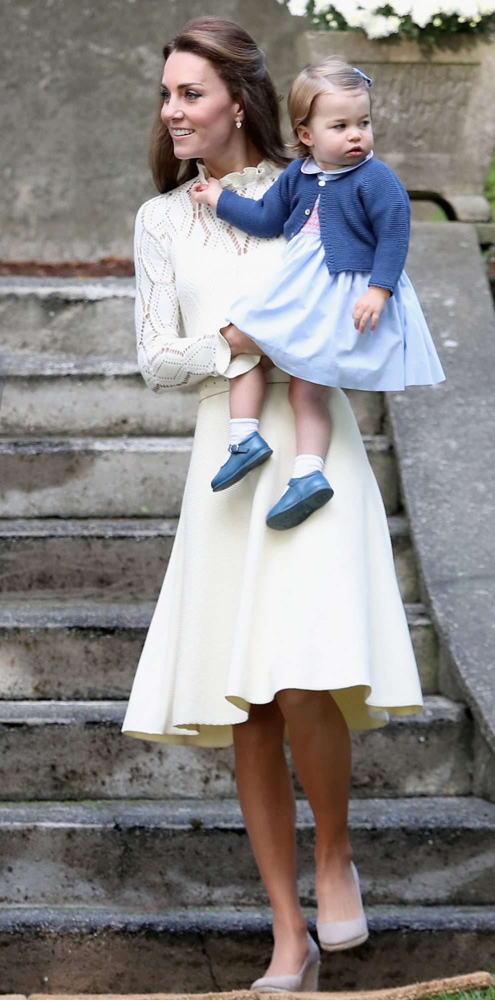 Kate Middleton in a cream pointelle-knit See by Chloé dress holding Charlotte