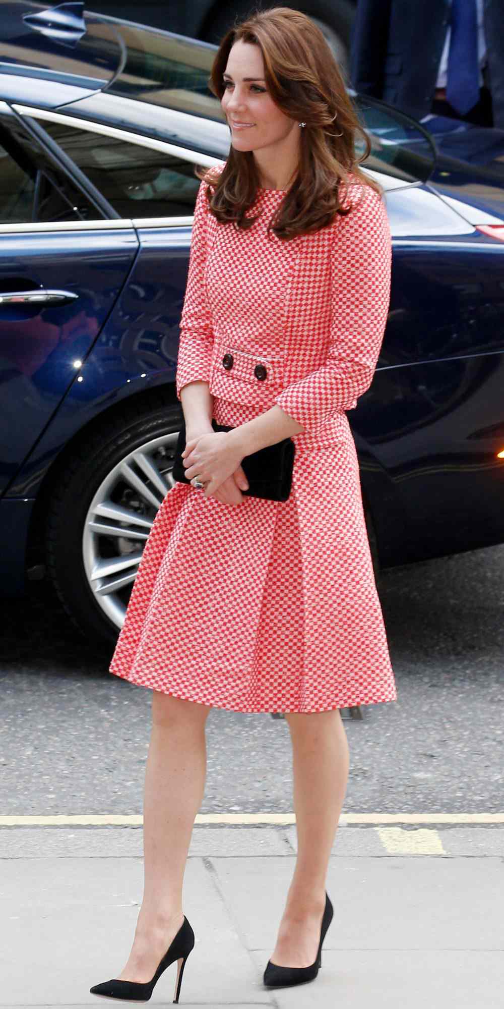 Kate Middleton in a matching red and white tweed top and skirt