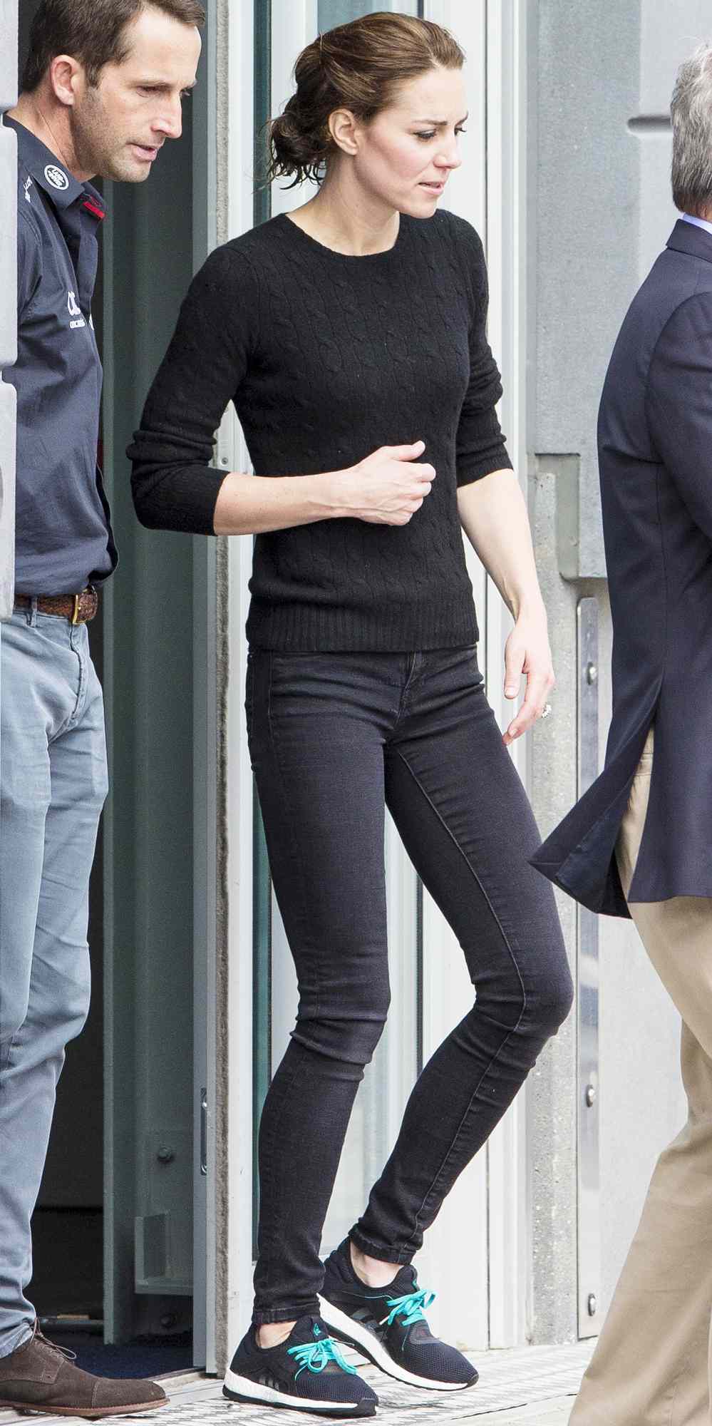 Kate Middleton in a black sweater, skinny jeans, and sneakers
