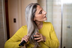 Mature Woman Brushing Her Hair