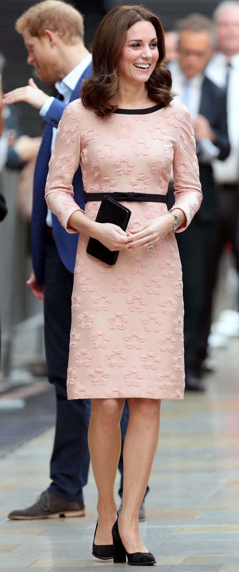 Kate Middleton in a pink dress with black detailing and block-heel pumps 