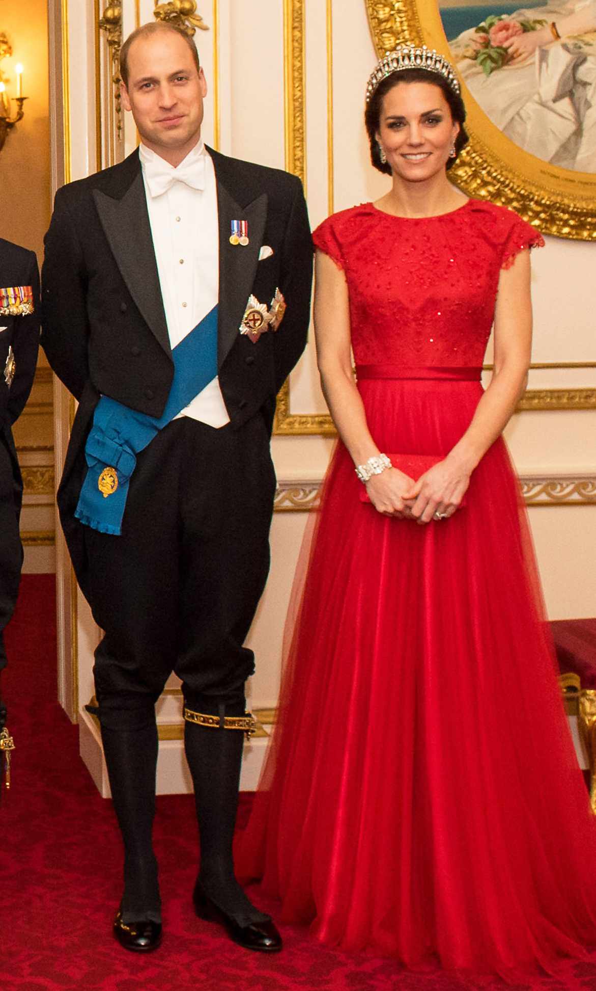 Kate Middleton in a red Jenny Packham gown and tiara alongside Prince William