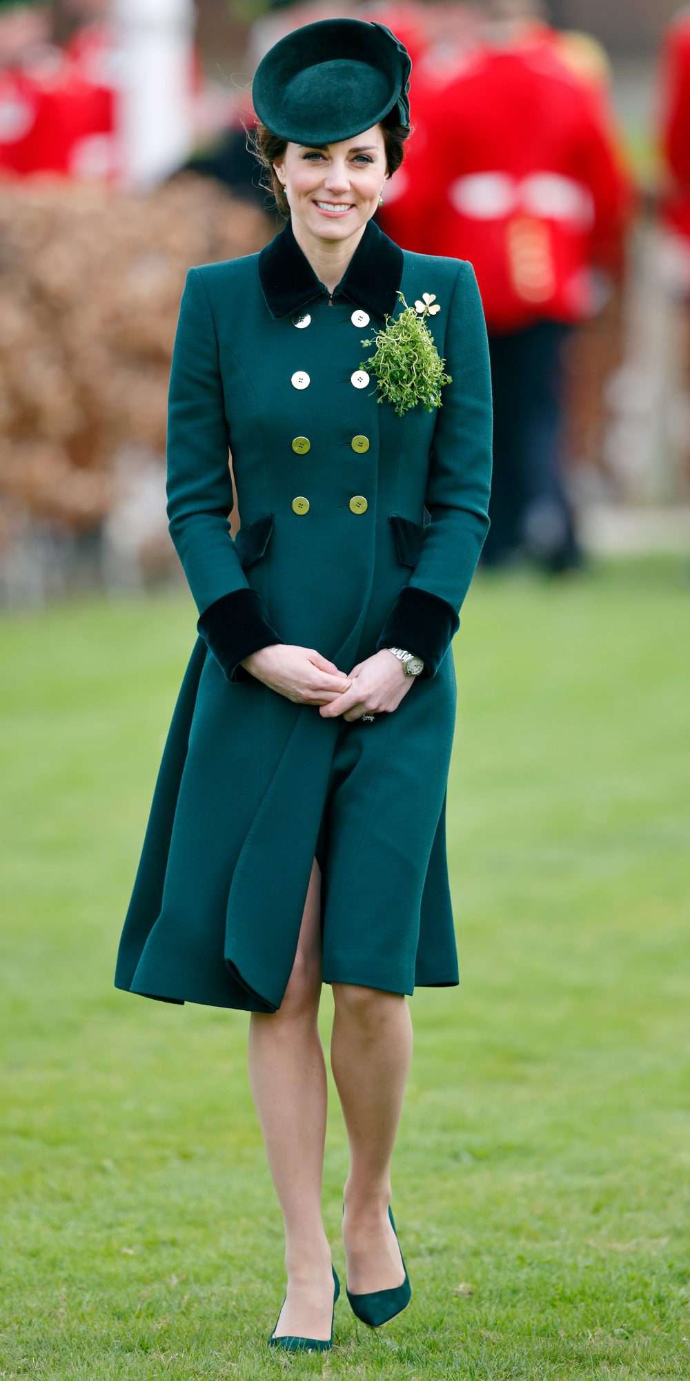 Kate Middleton in a dark green, double-breasted coat with black trim and gold buttons