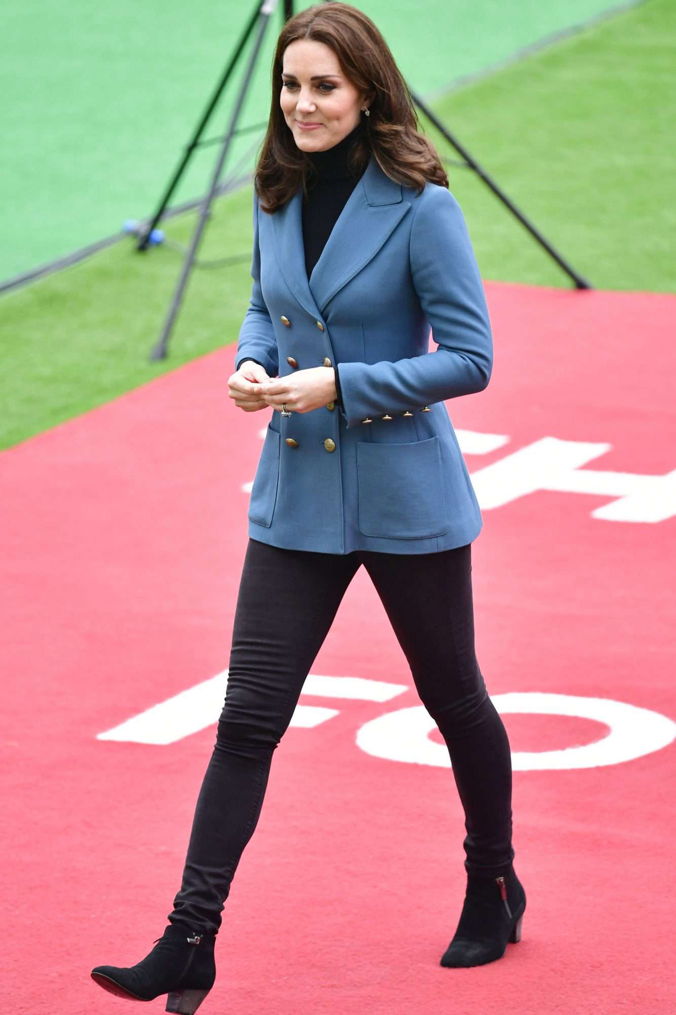 Kate Middleton in a blue double-breasted blazer, black skinnies, and booties