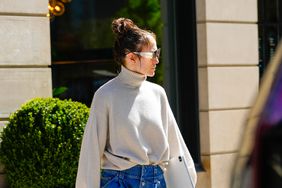 Jennifer Lopez wearing turtleneck and baggy jeans with white sneakers