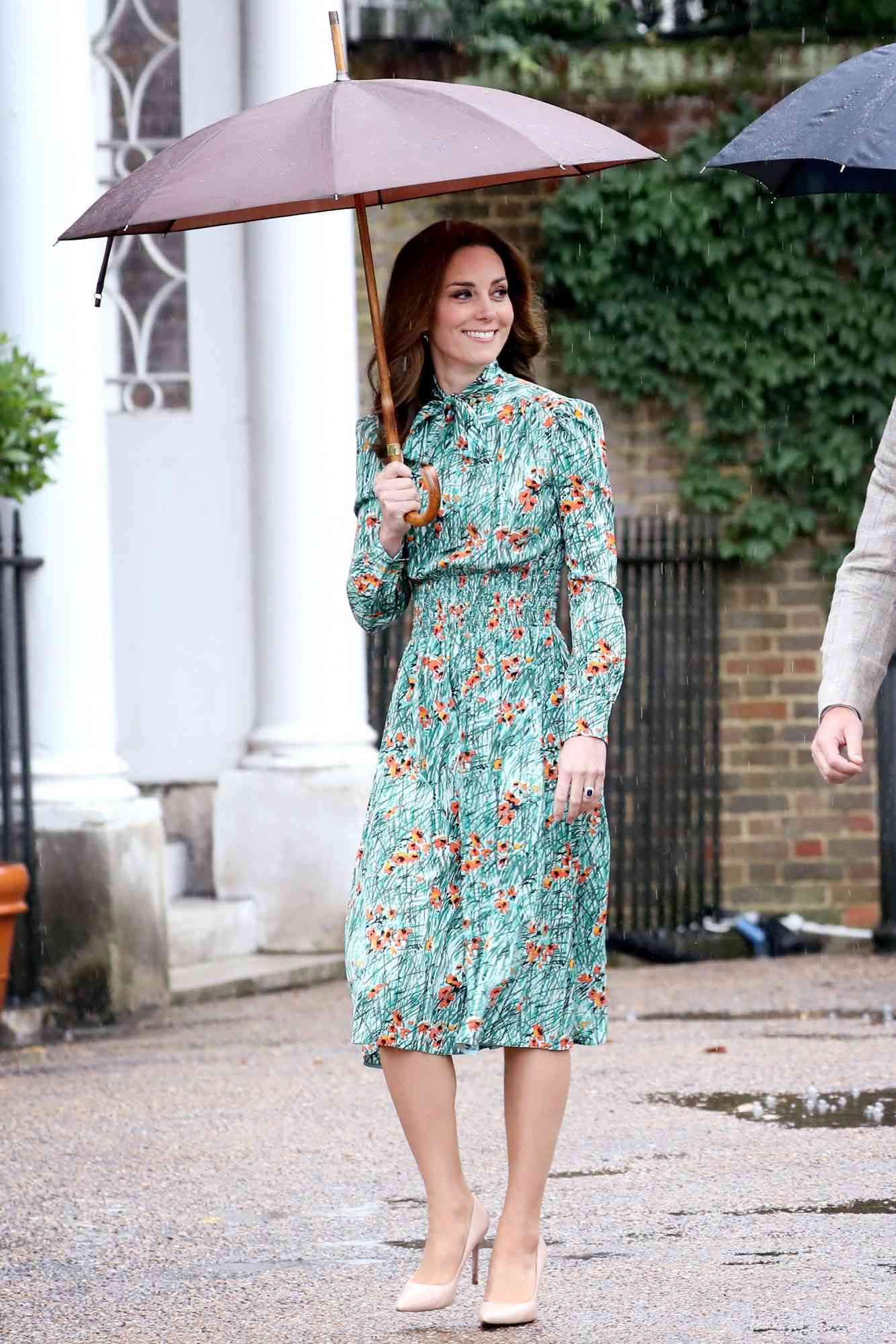 Kate Middleton wearing a floral green Prada tea-length dress 