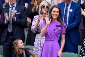 Kate Middleton Purple Dress Smiling and Waving Standing in Royal Box Next to Princess Charlotte at All England Lawn Tennis and Croquet Club 2024 Wimbledon