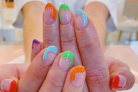 A swirly and colorful oval nail design.