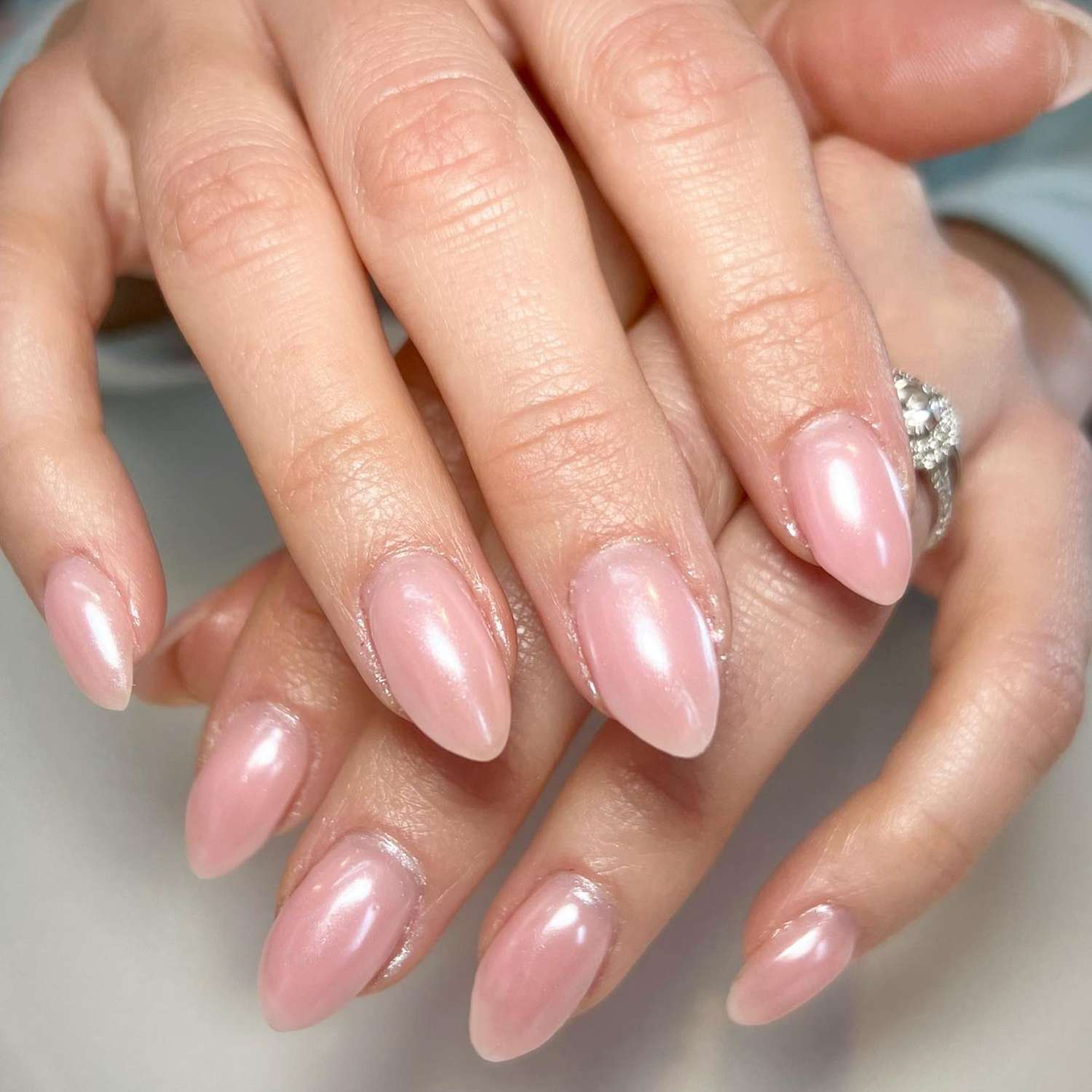 close up of nails with light pink chrome manicure 