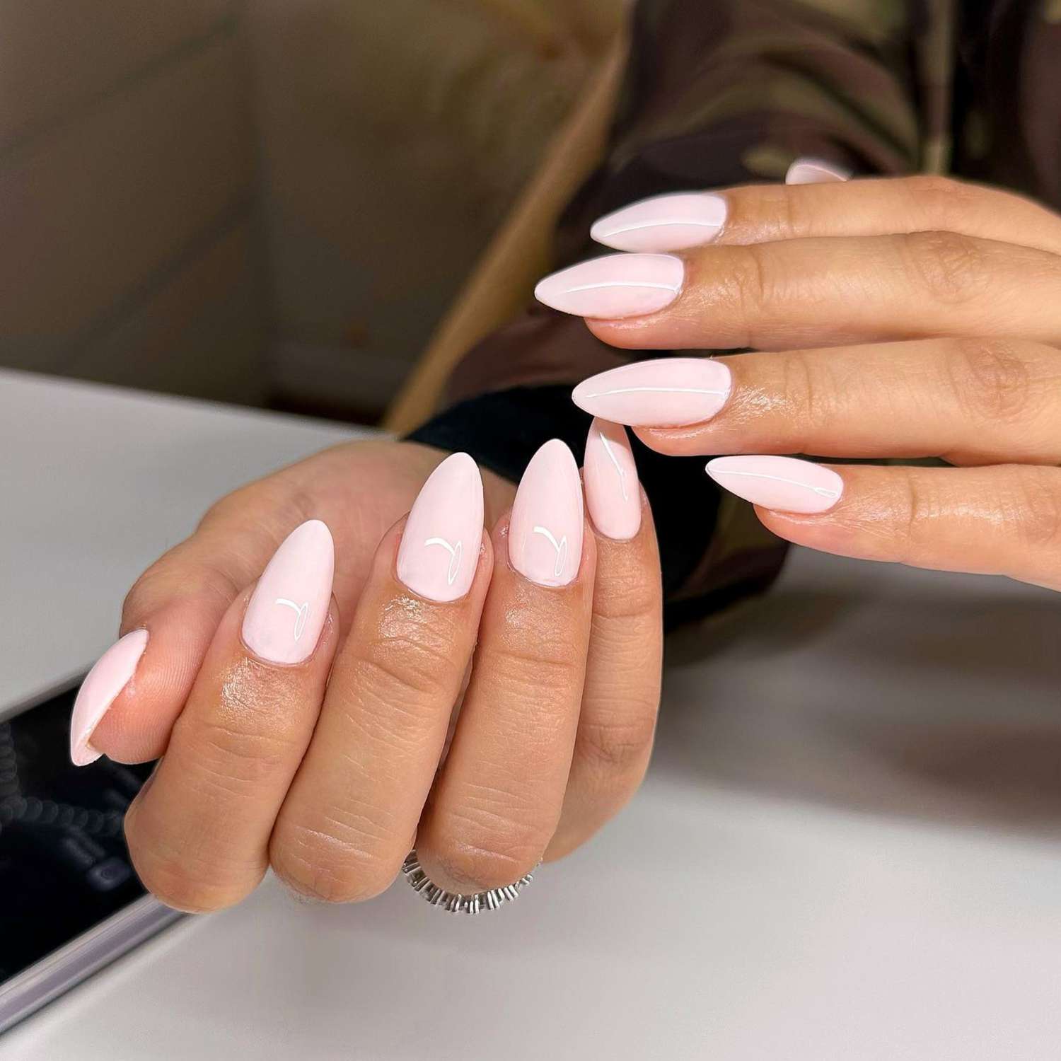 close up of nails with light pink manicure