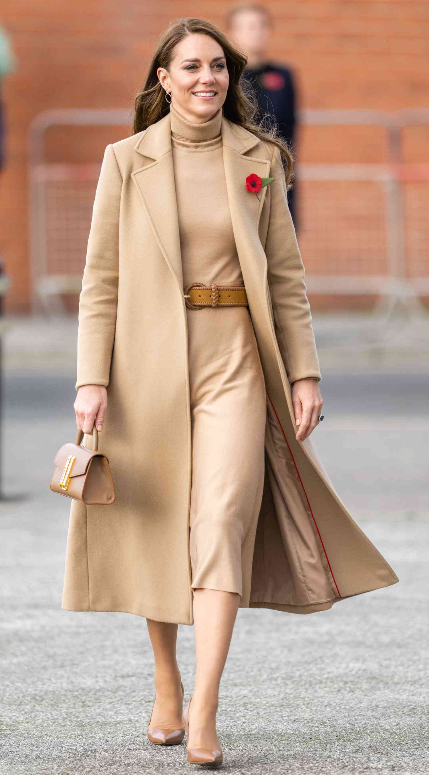 Kate Middleton in a monochromatic camel overcoat and belted sweater dress
