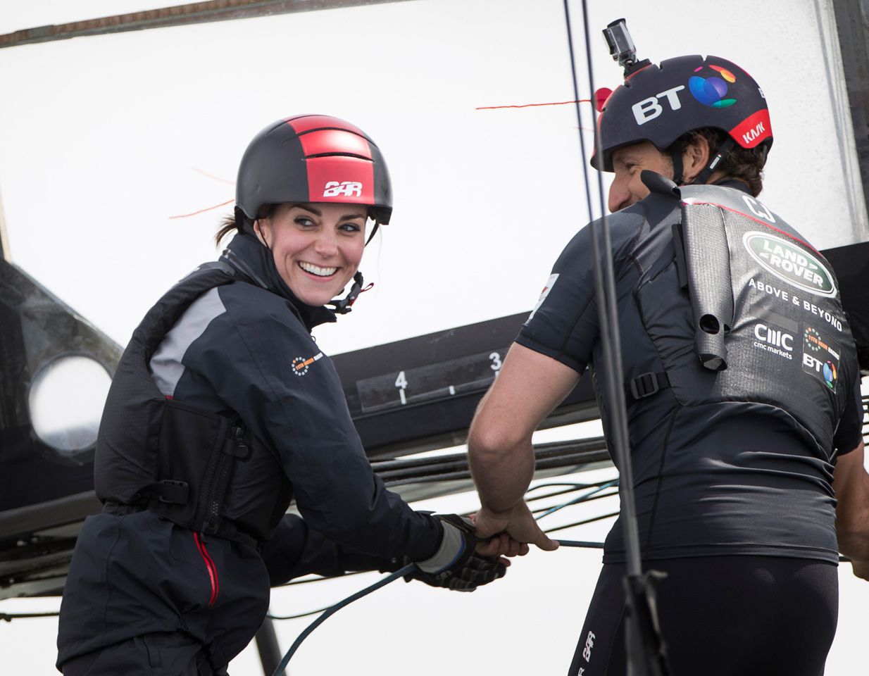 Kate Middleton wearing a helmet, black jacket, and life vest