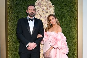 Jennifer Lopez Pink Rosette Gown Hand On Ben Affleck's Arm Posing at 2024 Golden Globes