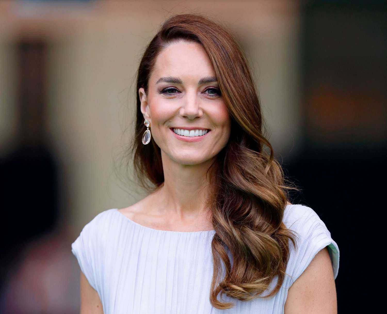 Kate Middleton with long, wavy hair and drop earrings