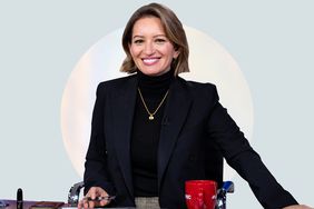 Katy Tur sitting at a desk wearing a black suit and turtleneck.