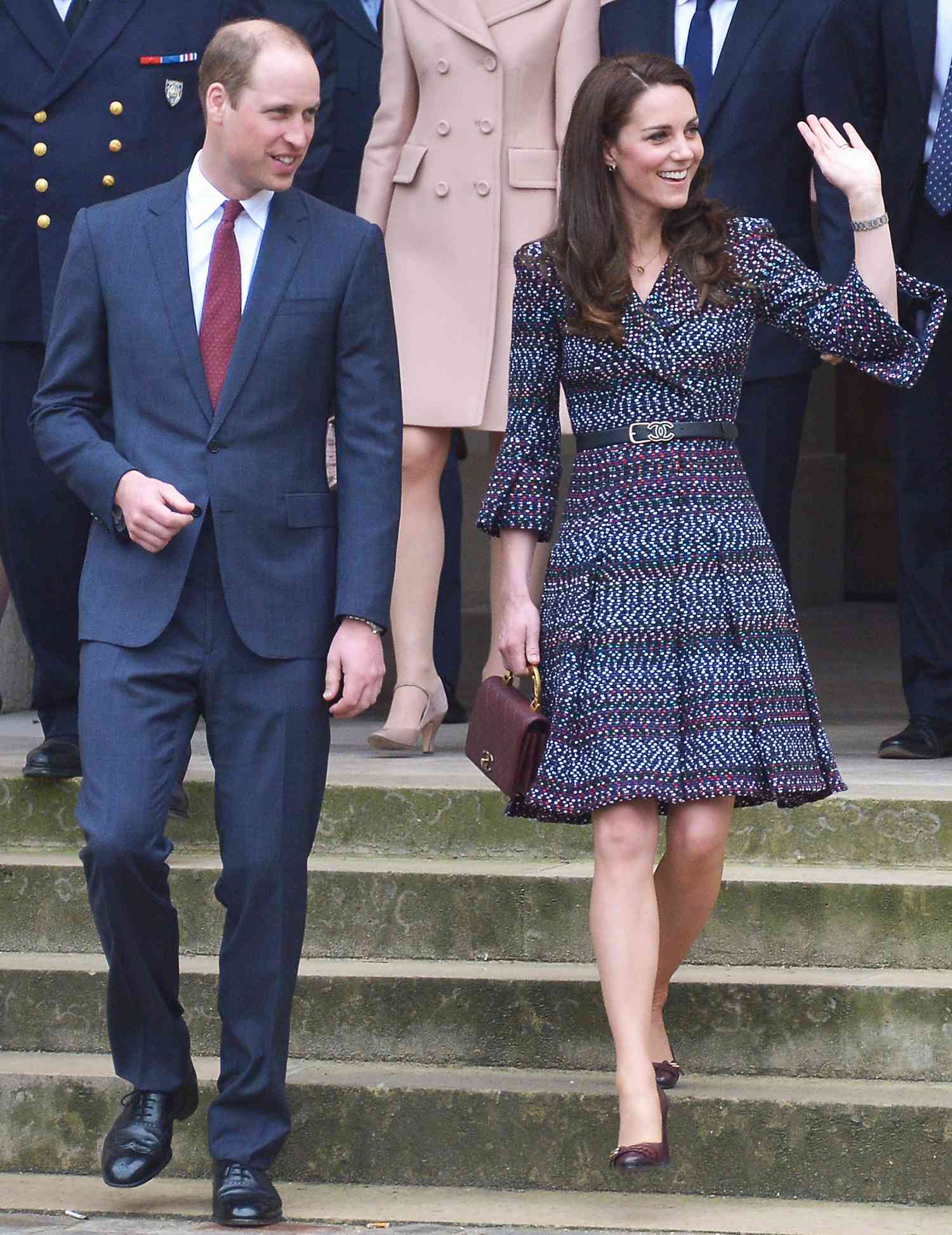 Kate Middleton in a printed blue Chanel dress with a double-C belt, and quilted handbag