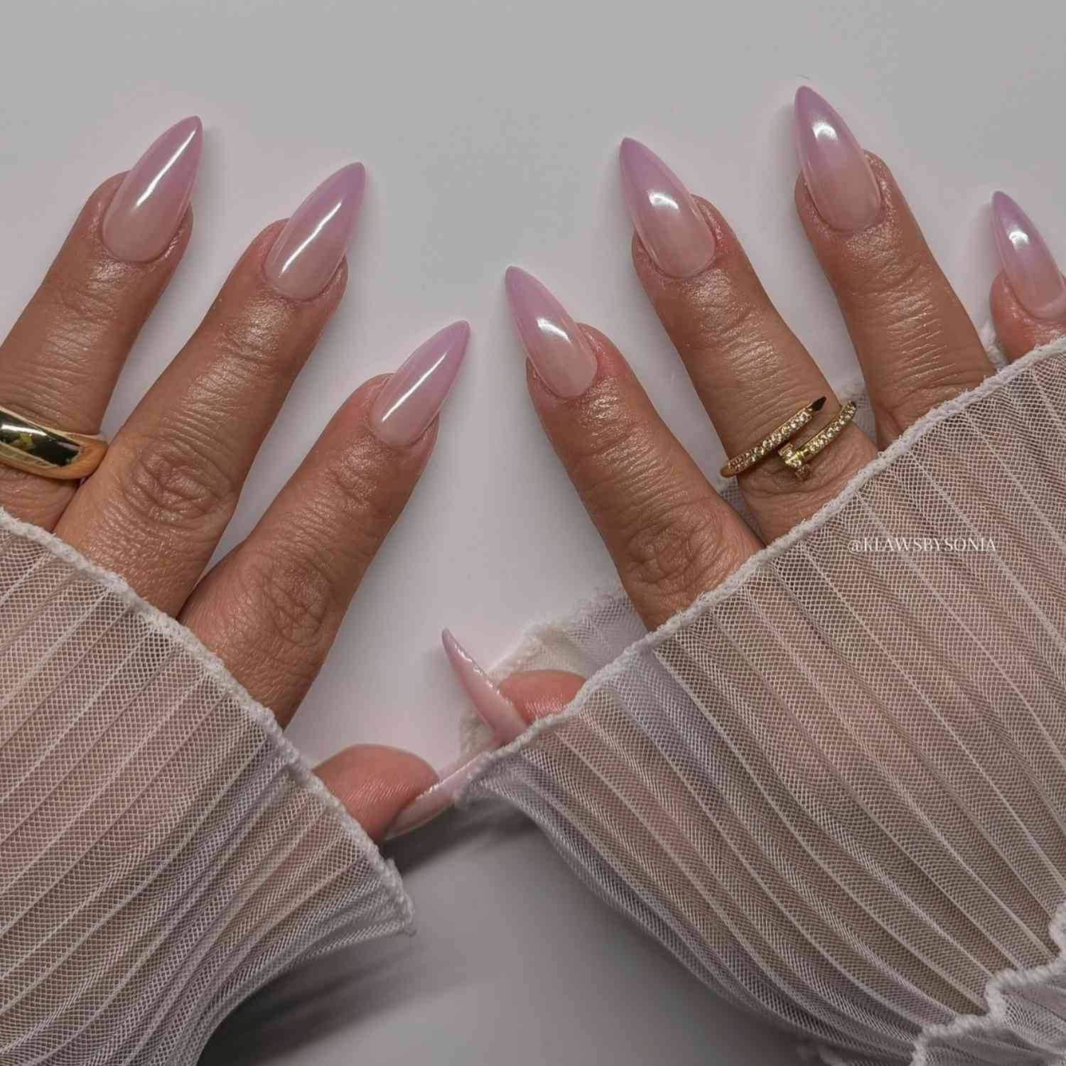 close up of nails with light pink french tip chrome manicure