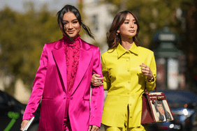 Women wear brightly colored suits