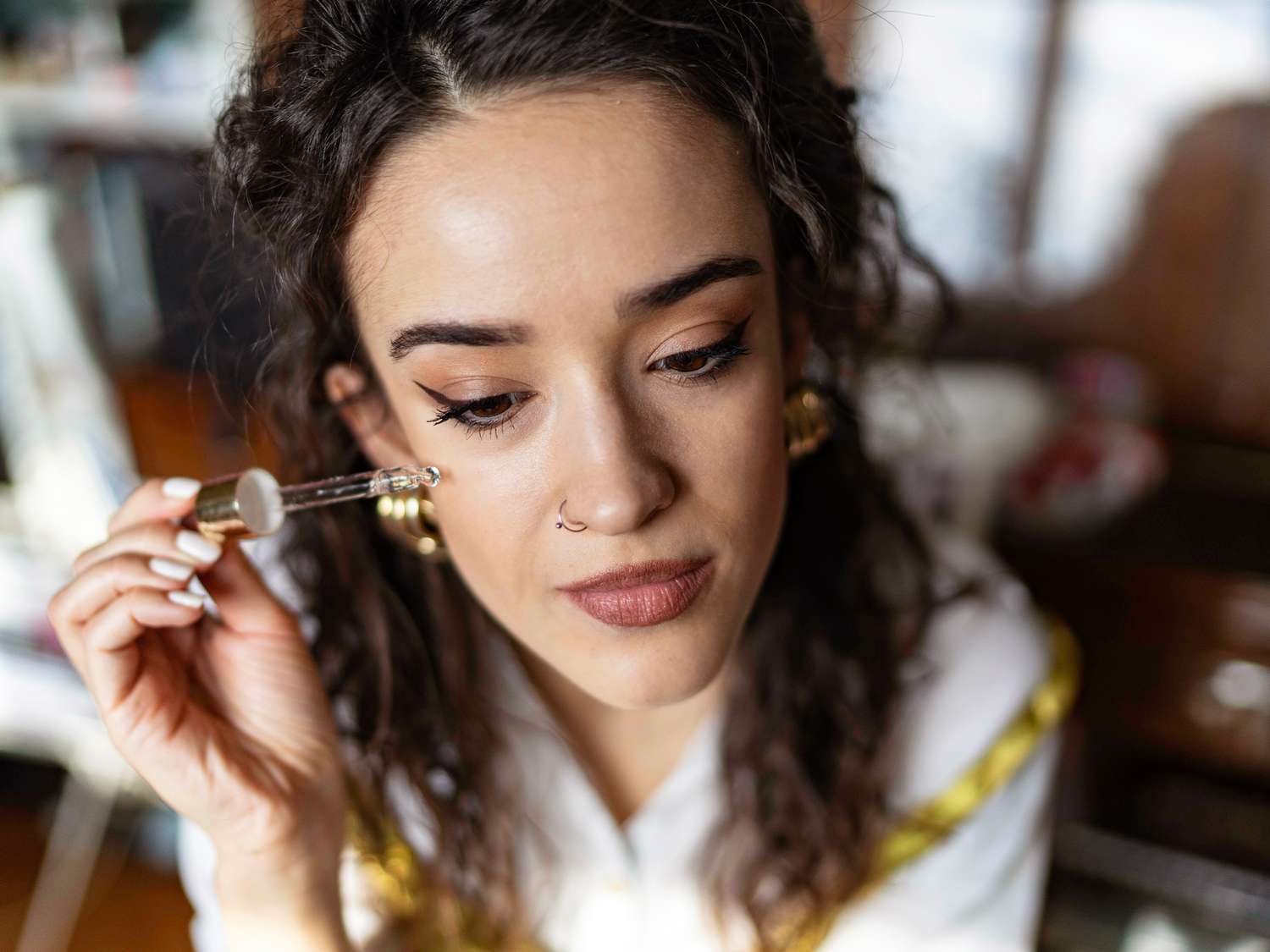 Woman Putting Serum on her Face