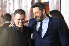 Ben Affleck with his hand on Matt Damon's shoulder, laughing