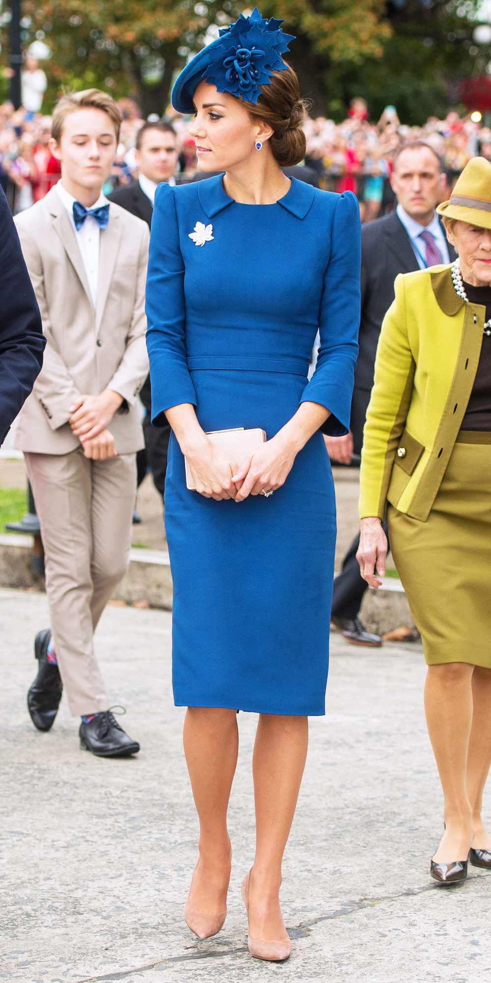 Kate Middleton in a collared blue sheath dress and matching hat