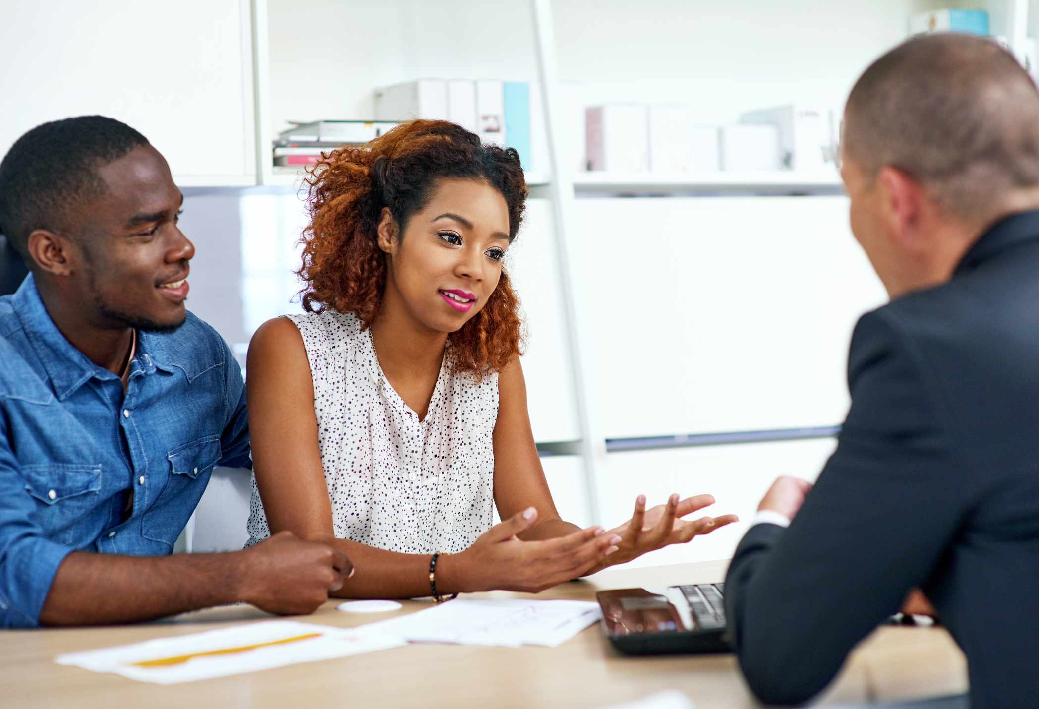 A shot of a young couple consulting a financial advisor.