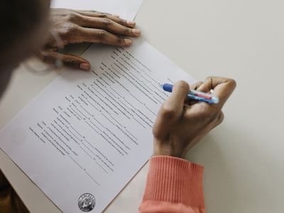 A person holding a pen taking a written exam