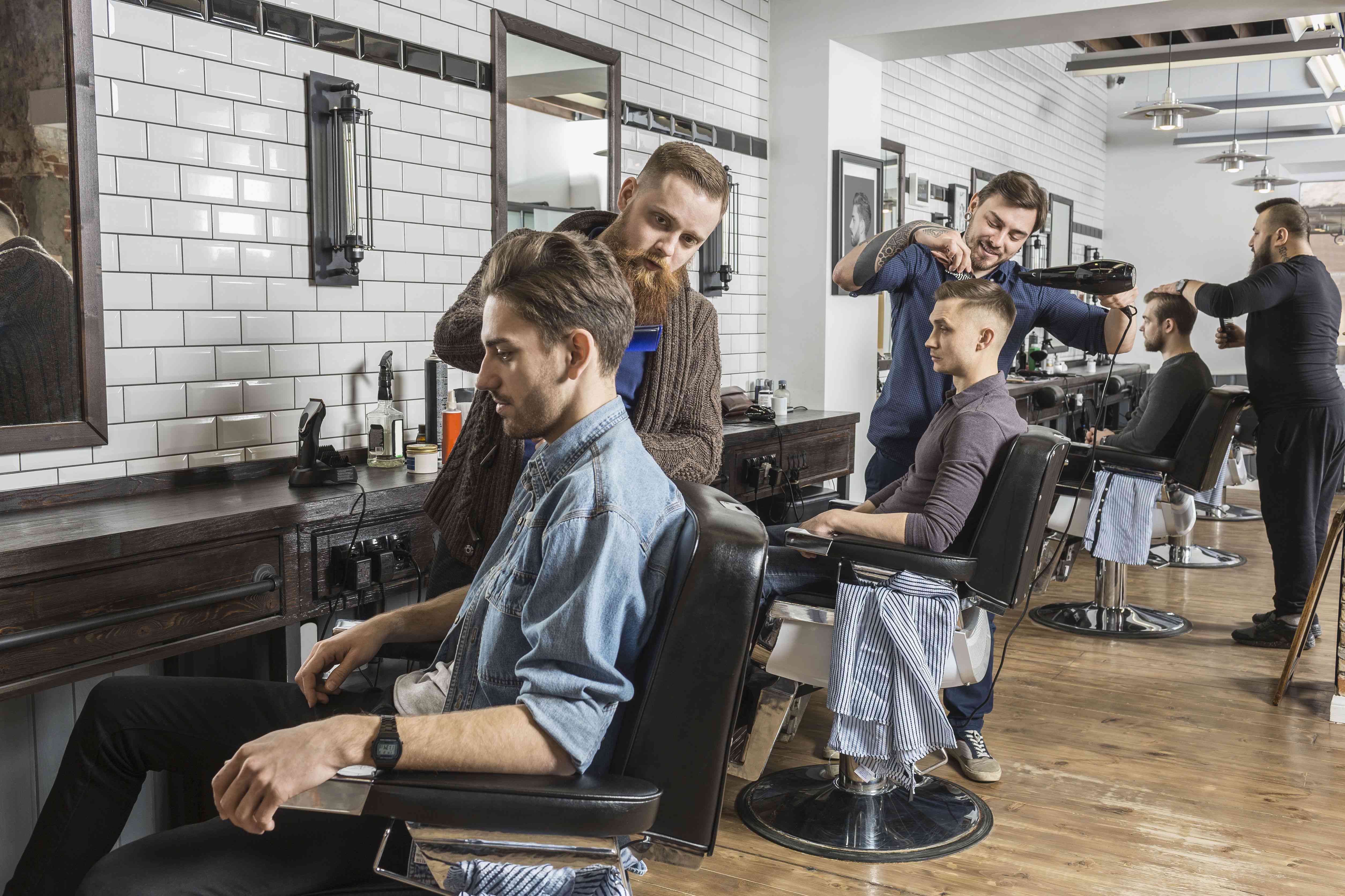 Barbers cutting customers' hair