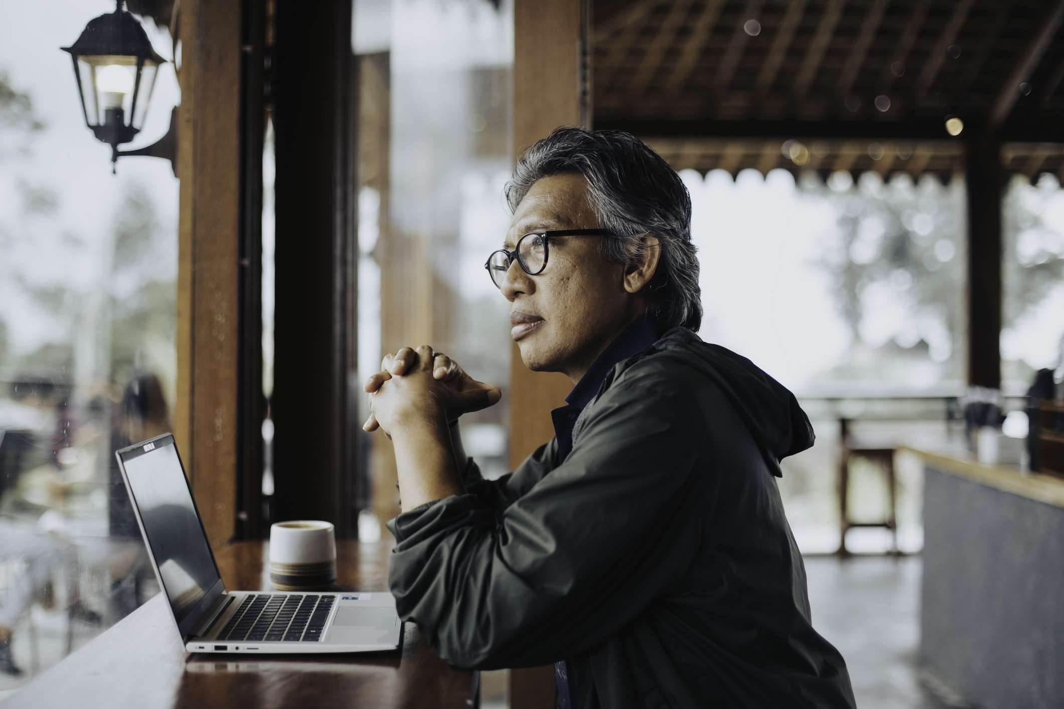 Man sitting in a cafe with a laptop