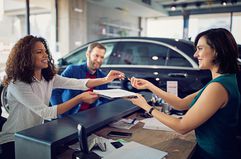 Couple is leasing new car and signing the contract