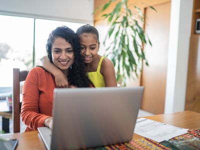 Mother and daughter using laptop