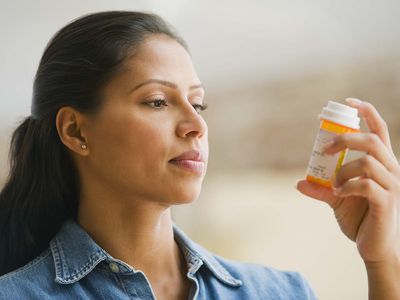 woman reading medication affordable health insurance