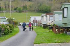 Couple walking their dogs in a manufactured home park