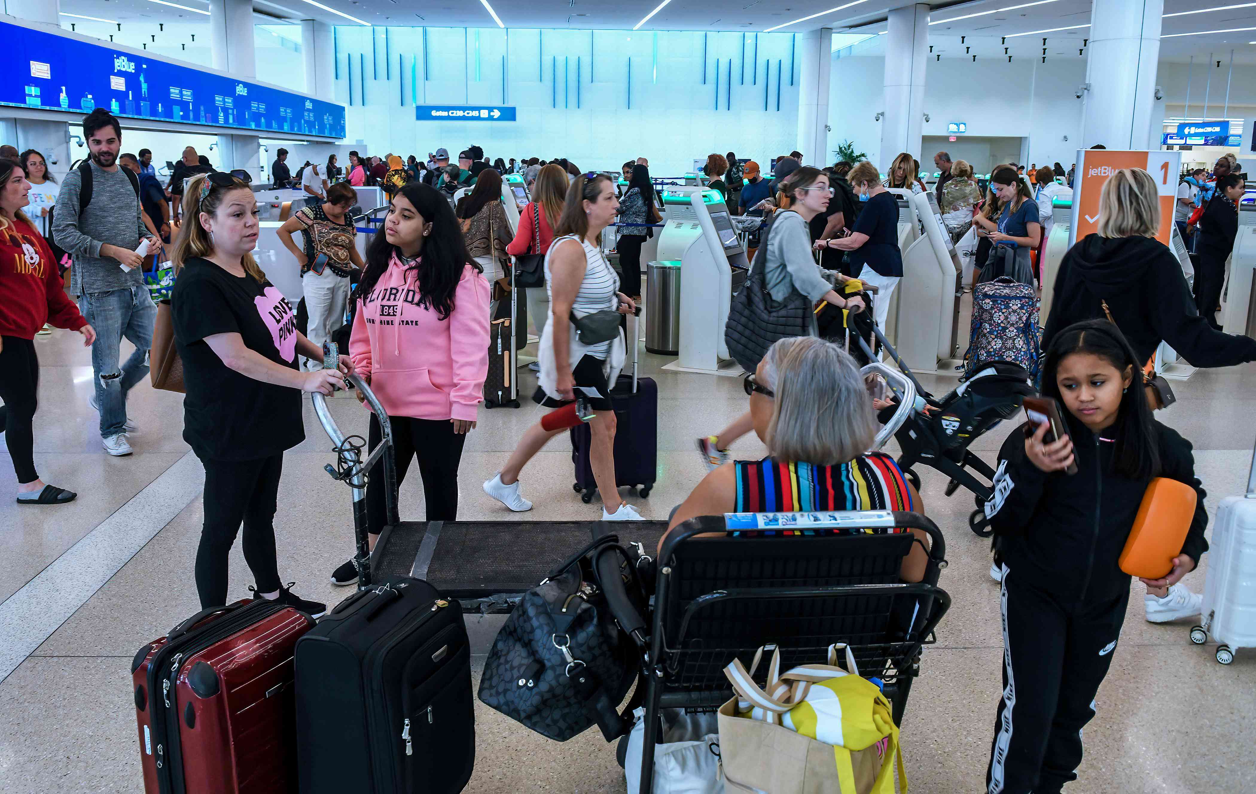 Travelers make their way through Orlando International Airport during the busy 2023 Labor Day holiday weekend