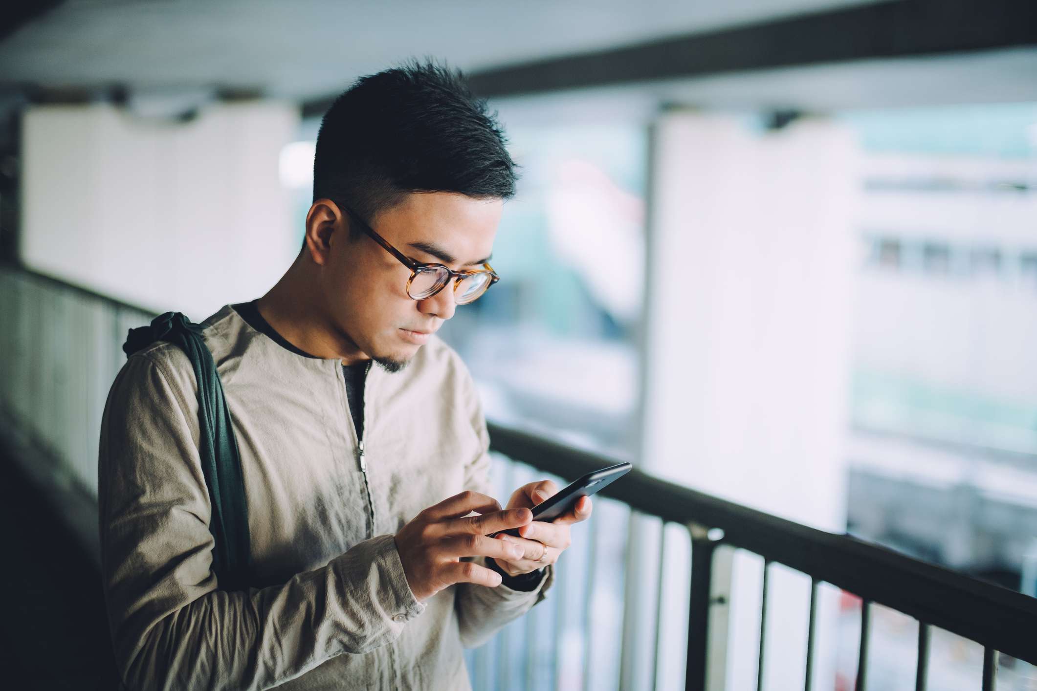 Young Man Uses Phone