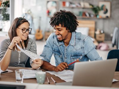 Young couple calculates monthly expenses at home