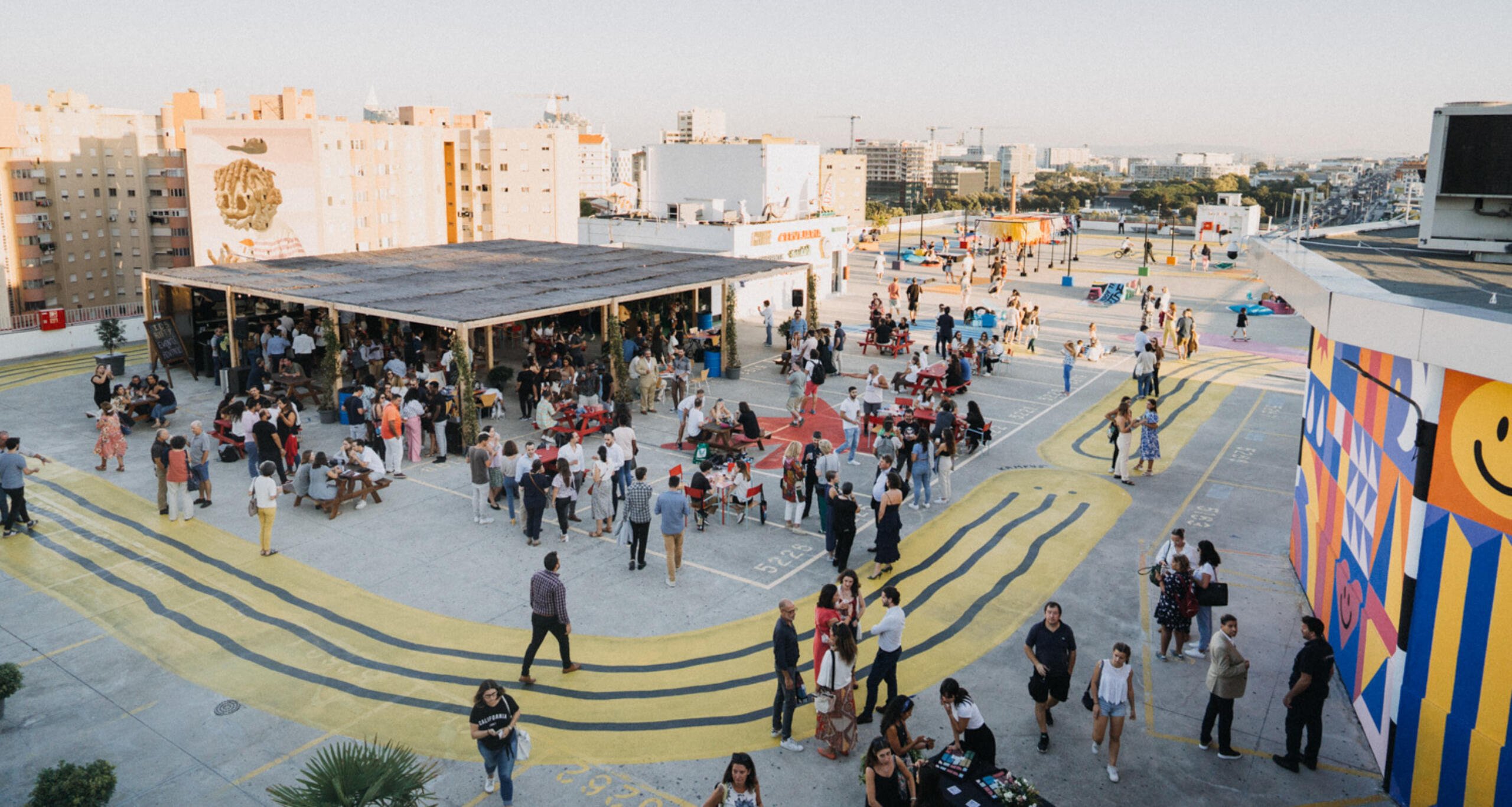 Large group of people attending an event on IDB Lisbon's rooftop