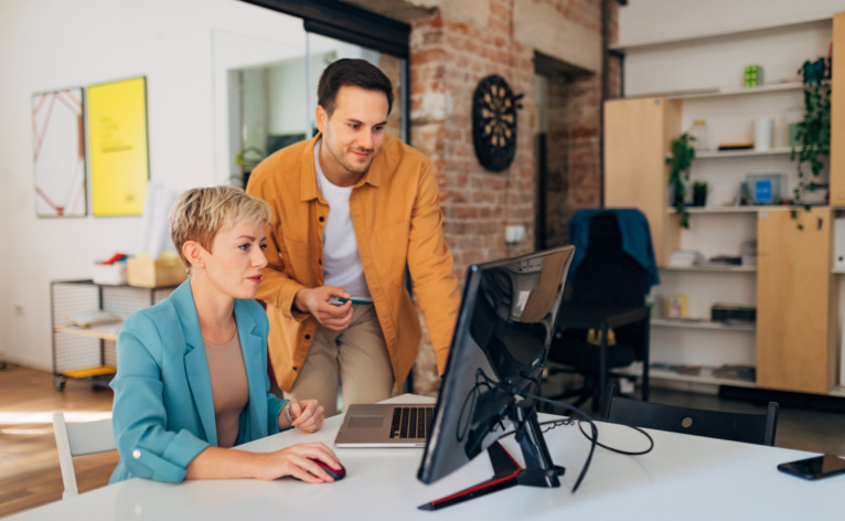 Colleagues working together on a computer