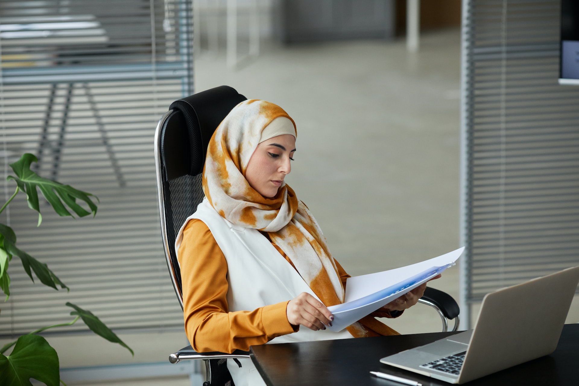 woman working at desk looking at paper career service