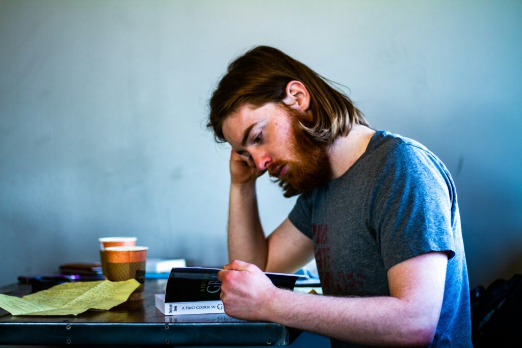 guy looking at book stressed