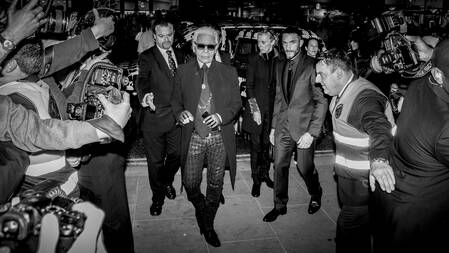 The arrival of legendary fashion designer Karl Lagerfeld at the opening of the London Regent Street store is met by a crowd of eagerly awaiting photographers.​