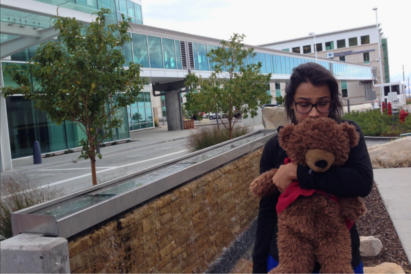 Shae holding a teddy bear after dignosis