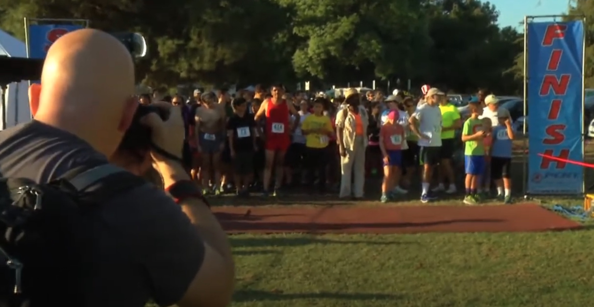 Group of walkers being photographed at the finish line